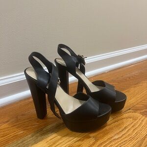 Call It Spring black high heels with a ~4.5 inch heel and strap